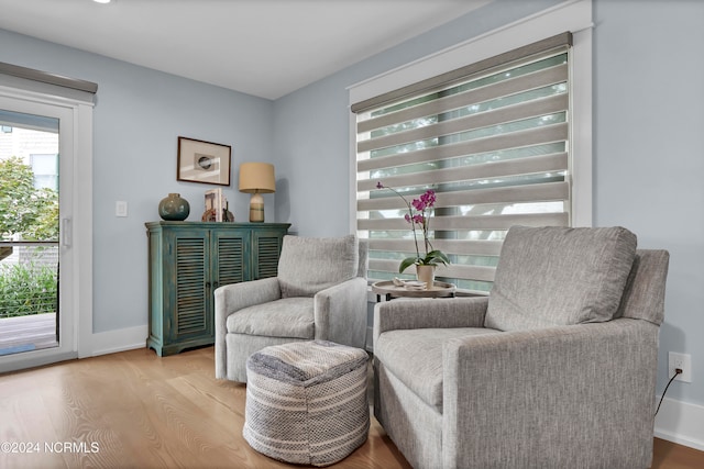 sitting room featuring baseboards and wood finished floors