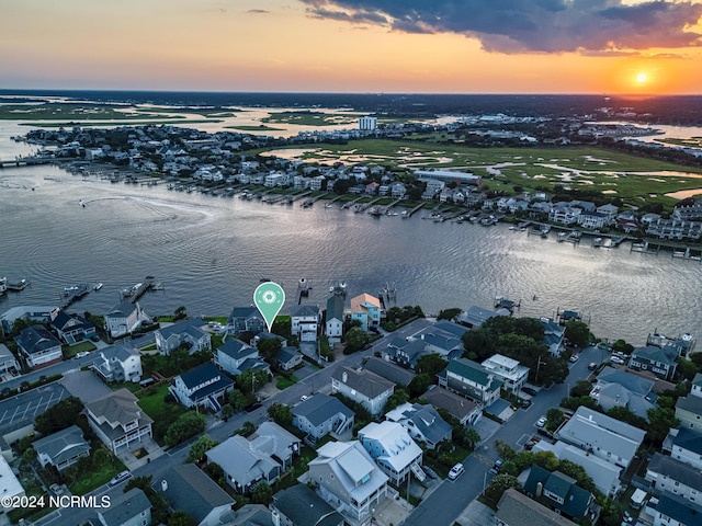 drone / aerial view featuring a water view and a residential view