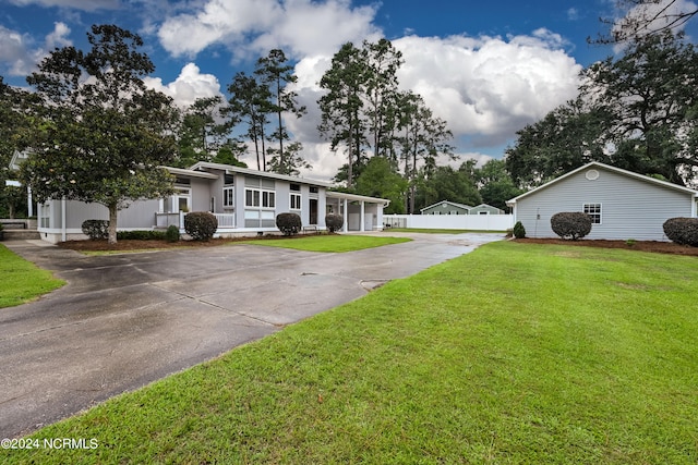 ranch-style home with a front lawn