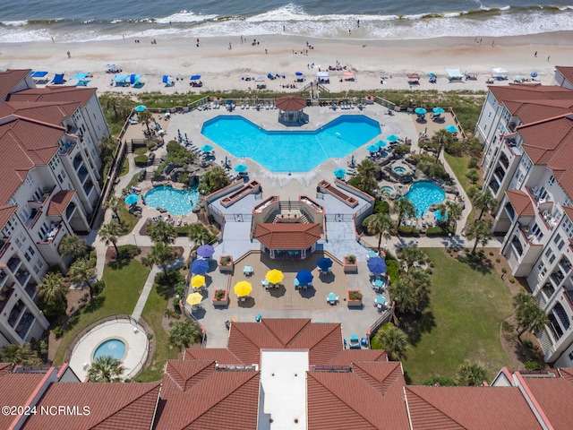 birds eye view of property with a beach view and a water view