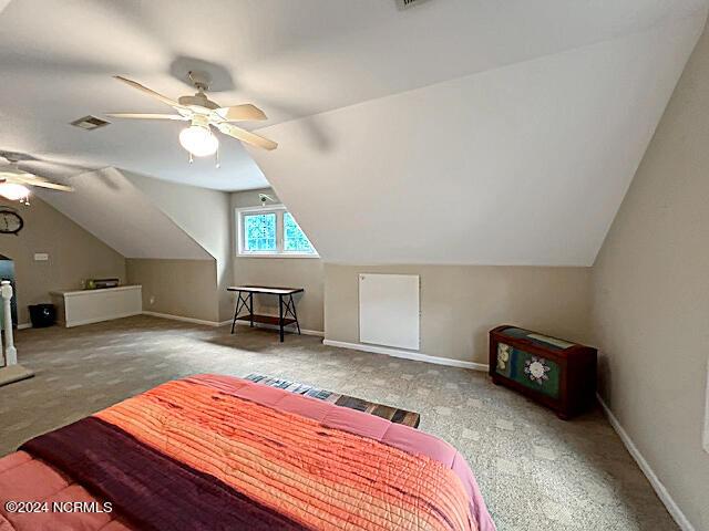 bedroom featuring vaulted ceiling, a ceiling fan, visible vents, and baseboards