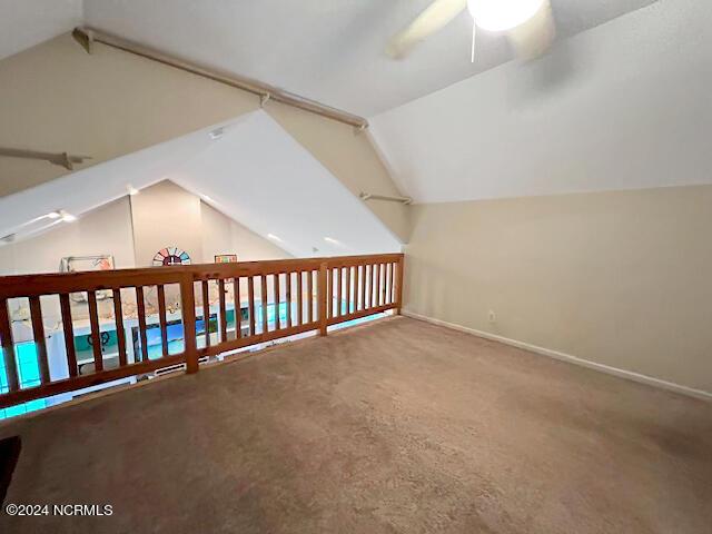 bonus room with a ceiling fan, vaulted ceiling, carpet floors, and baseboards