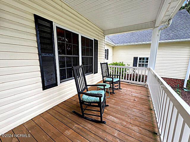 wooden terrace with a porch