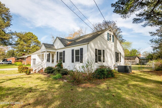 view of property exterior featuring a lawn and cooling unit