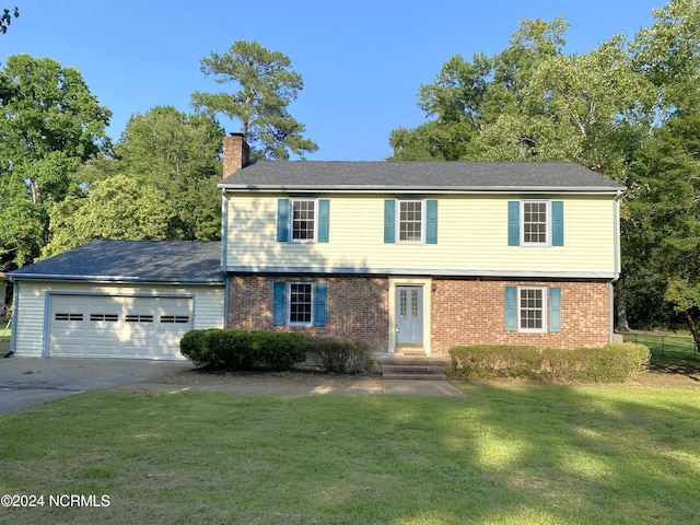 view of front facade with a front lawn and a garage