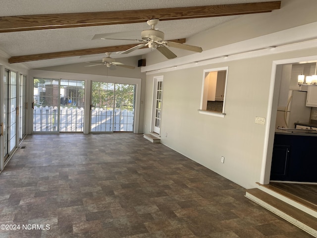 interior space with a textured ceiling, stone finish floor, and vaulted ceiling with beams