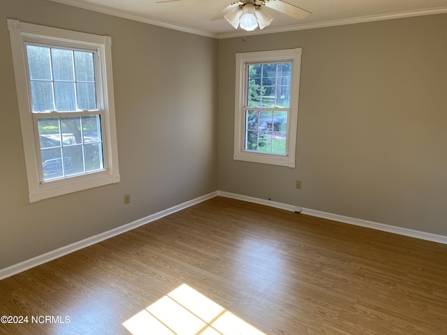 unfurnished room featuring ceiling fan, ornamental molding, wood finished floors, and baseboards