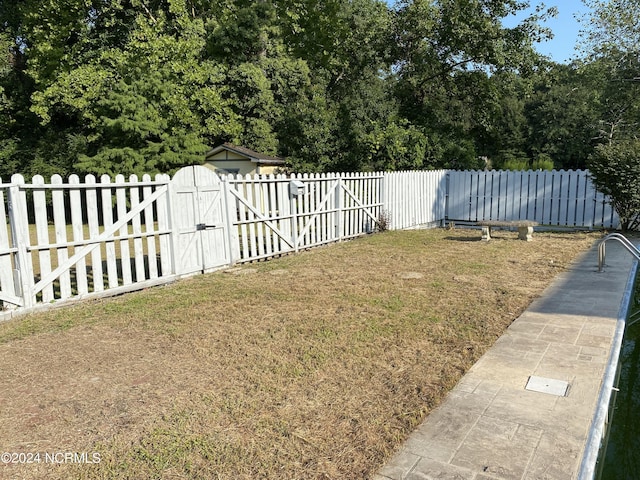 view of yard with fence and a gate