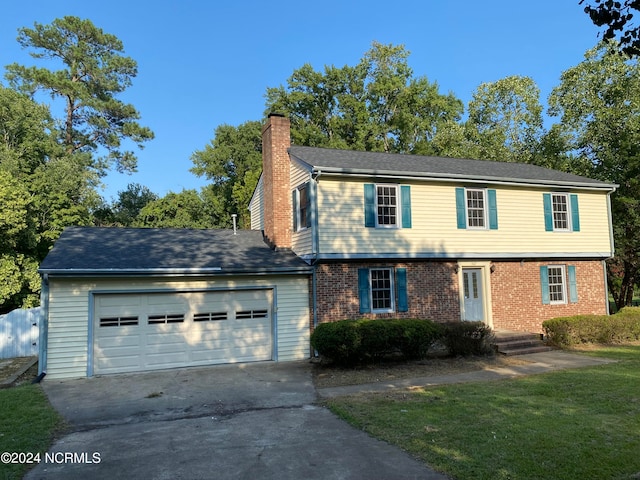 view of front of property featuring a garage and a front lawn