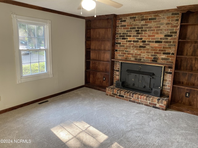 unfurnished living room with baseboards, visible vents, crown molding, built in shelves, and a fireplace