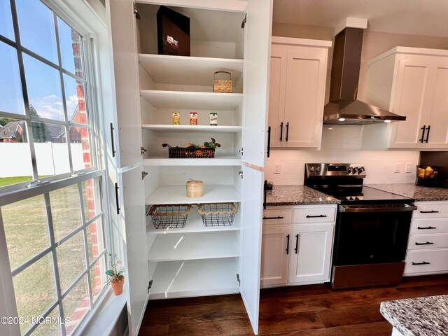 3701 Greystone Dr, Rocky Mount, NC 27804 - kitchen with stainless steel range with electric cooktop, wall chimney exhaust hood, white cabinets, stone countertops, and dark wood-style flooring
