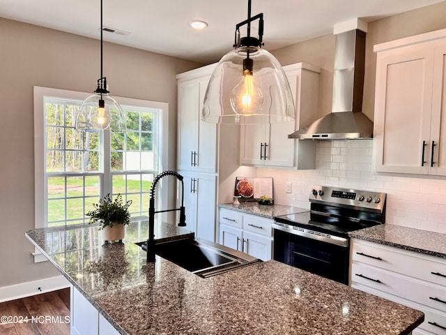 kitchen with electric range, decorative backsplash, dark wood-type flooring, a sink, and wall chimney exhaust hood