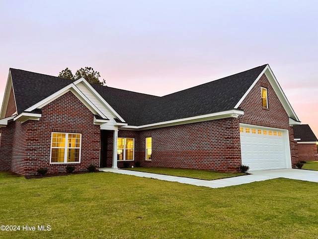 3701 Greystone Dr, Rocky Mount, NC 27804 - view of front of home featuring a garage, a front yard, and brick siding