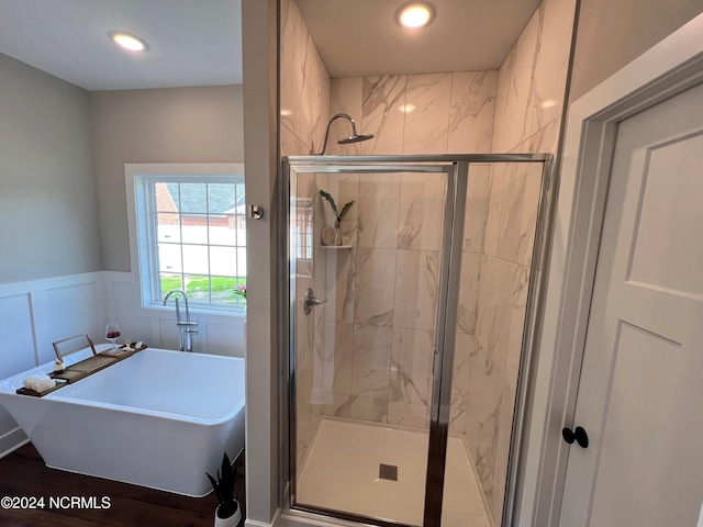 3701 Greystone Dr, Rocky Mount, NC 27804 - bathroom with a soaking tub, a decorative wall, recessed lighting, wainscoting, and a stall shower