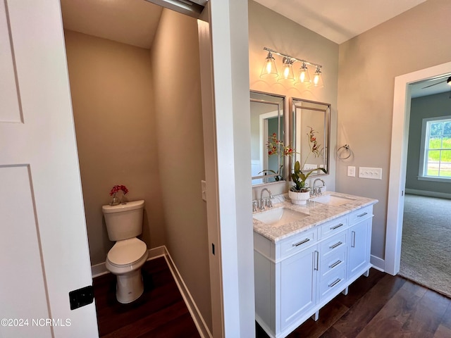 3701 Greystone Dr, Rocky Mount, NC 27804 - bathroom with toilet, wood finished floors, a sink, and baseboards