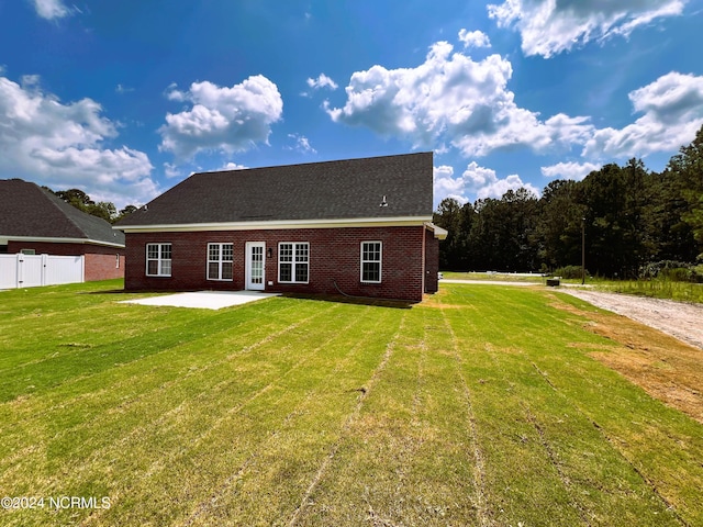3701 Greystone Dr, Rocky Mount, NC 27804 - back of house featuring a patio, brick siding, fence, and a lawn