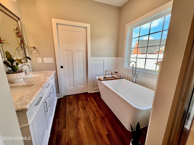3701 Greystone Dr, Rocky Mount, NC 27804 - full bath featuring a sink, a soaking tub, double vanity, wainscoting, and wood finished floors