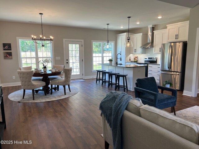 3701 Greystone Dr, Rocky Mount, NC 27804 - living room featuring dark wood-type flooring, a notable chandelier, baseboards, and recessed lighting