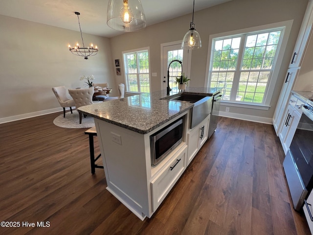 3701 Greystone Dr, Rocky Mount, NC 27804 - kitchen featuring an inviting chandelier, white cabinets, dark wood-type flooring, appliances with stainless steel finishes, and a sink