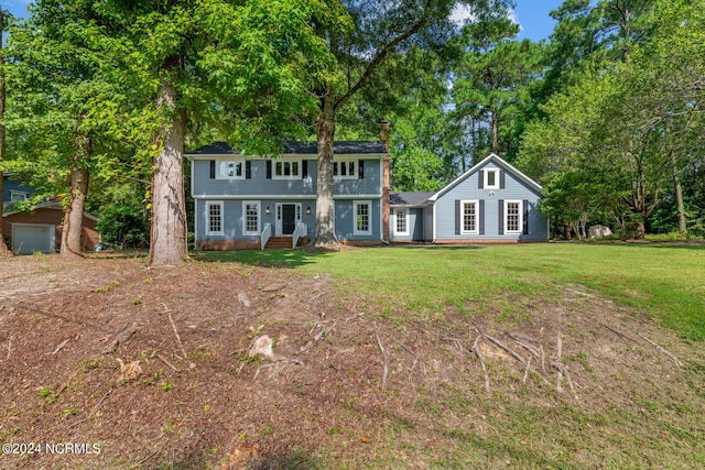 colonial home with a front lawn