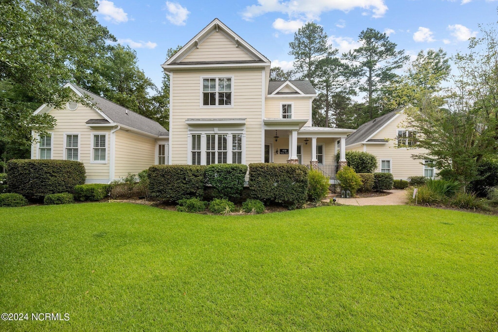 view of front facade with a front lawn and covered porch