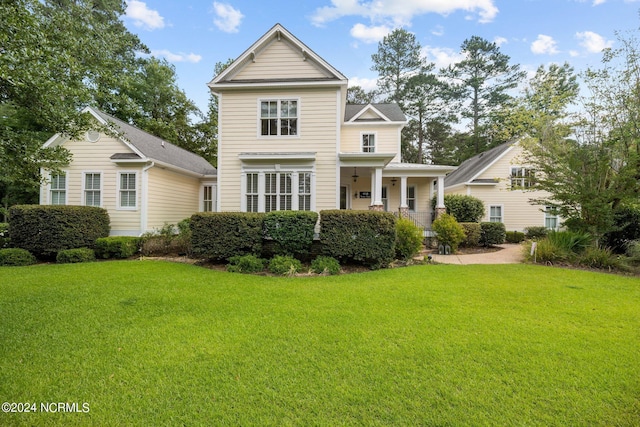 view of front facade with a front lawn and covered porch