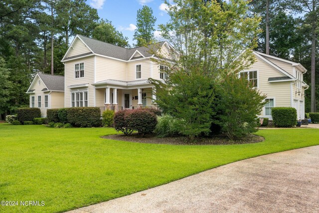 view of front of home with a porch and a front lawn