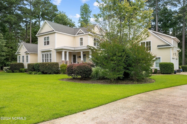 view of front of property with covered porch and a front lawn