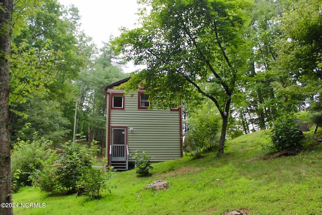 view of side of home featuring a yard