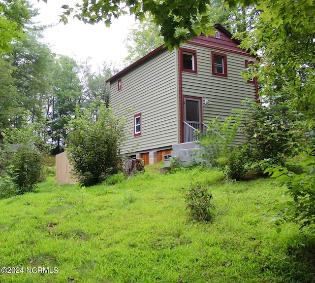 view of side of home with a lawn