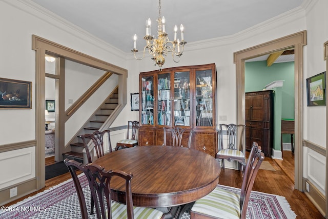 dining space featuring stairs, a chandelier, wood finished floors, and crown molding