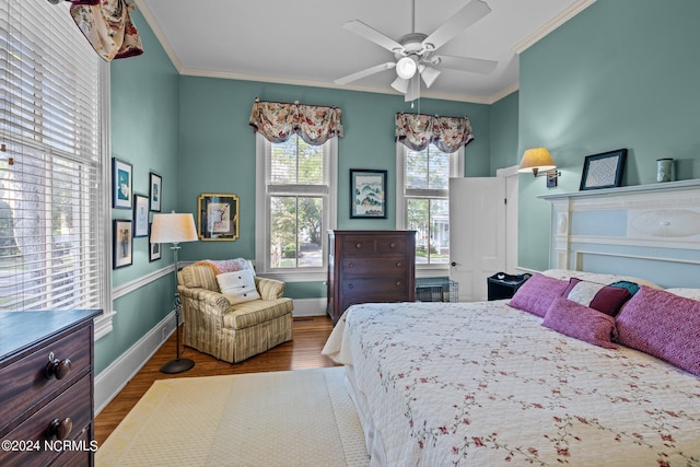 bedroom featuring baseboards, ceiling fan, wood finished floors, and crown molding