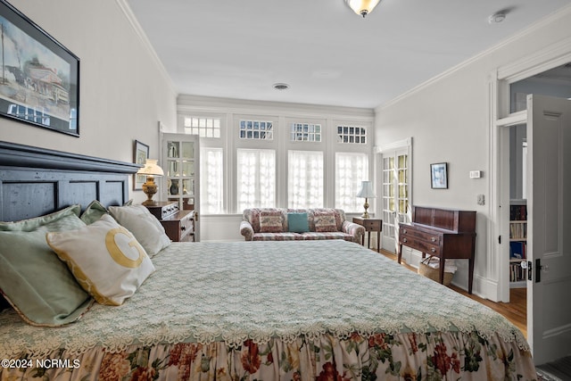 bedroom featuring ornamental molding, wood finished floors, and visible vents