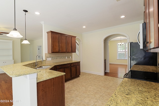 kitchen with tasteful backsplash, light stone counters, kitchen peninsula, light tile patterned flooring, and hanging light fixtures