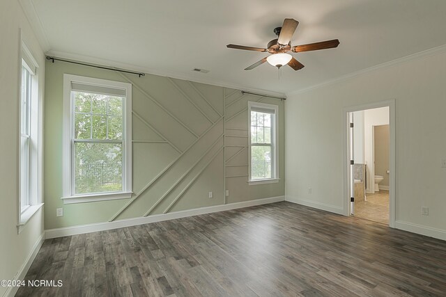 spare room with plenty of natural light, ceiling fan, hardwood / wood-style floors, and crown molding