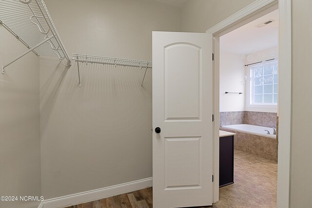 spacious closet featuring hardwood / wood-style floors