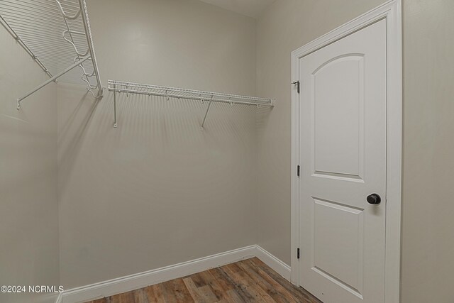 spacious closet featuring hardwood / wood-style flooring