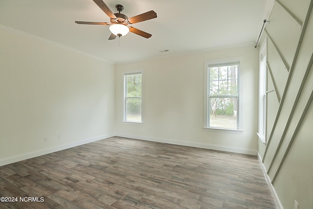 empty room featuring ceiling fan, hardwood / wood-style floors, and crown molding