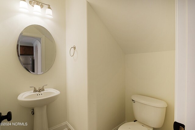 bathroom with vaulted ceiling and toilet