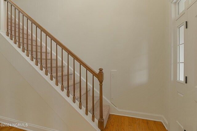 stairway with hardwood / wood-style flooring