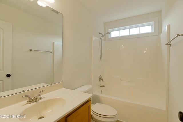 full bathroom featuring bathing tub / shower combination, toilet, and vanity