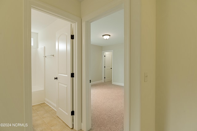 hallway featuring light carpet