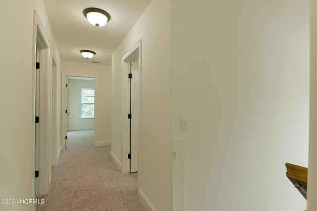 corridor with light colored carpet