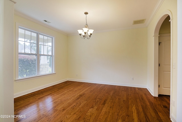 unfurnished room with crown molding, dark wood-type flooring, and a notable chandelier