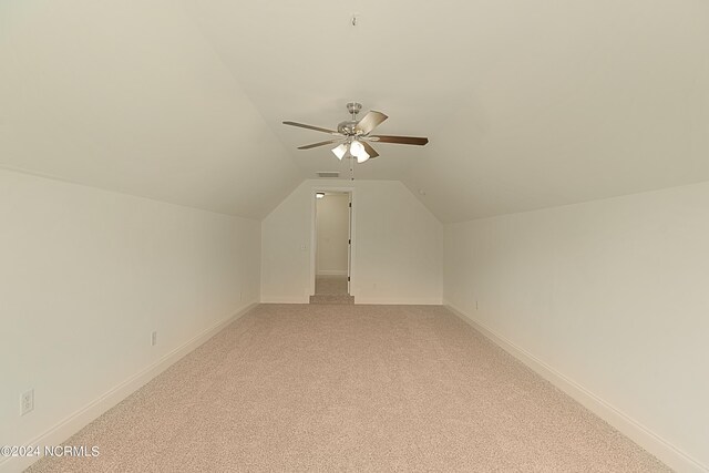 bonus room featuring ceiling fan, vaulted ceiling, and light colored carpet