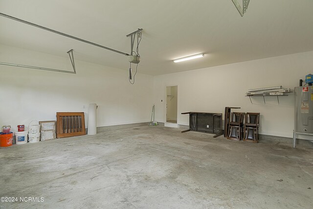 garage featuring a garage door opener and water heater