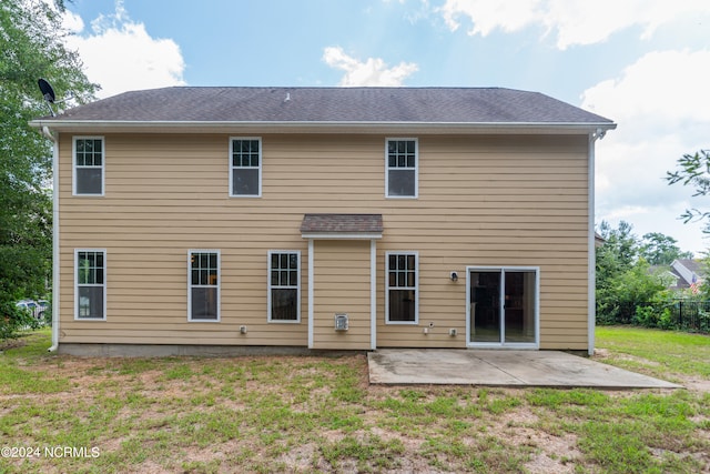 rear view of property with a patio area and a yard