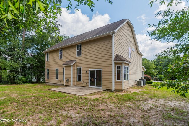 back of property featuring a patio, central air condition unit, and a lawn