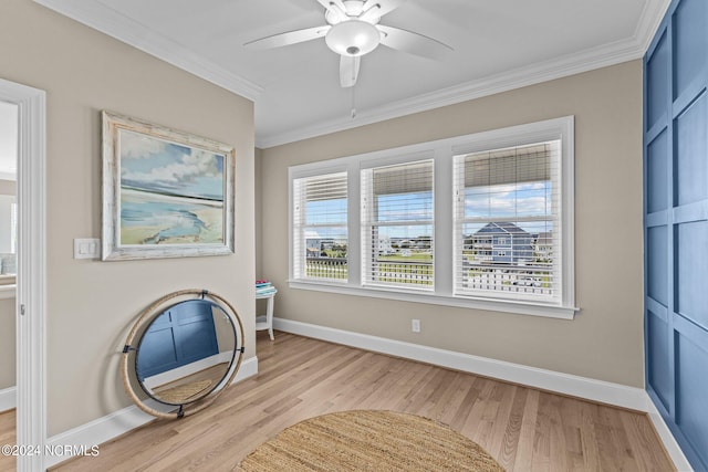 unfurnished room featuring ceiling fan, light hardwood / wood-style flooring, and ornamental molding