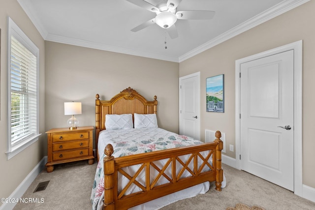 bedroom featuring ceiling fan, crown molding, and light colored carpet